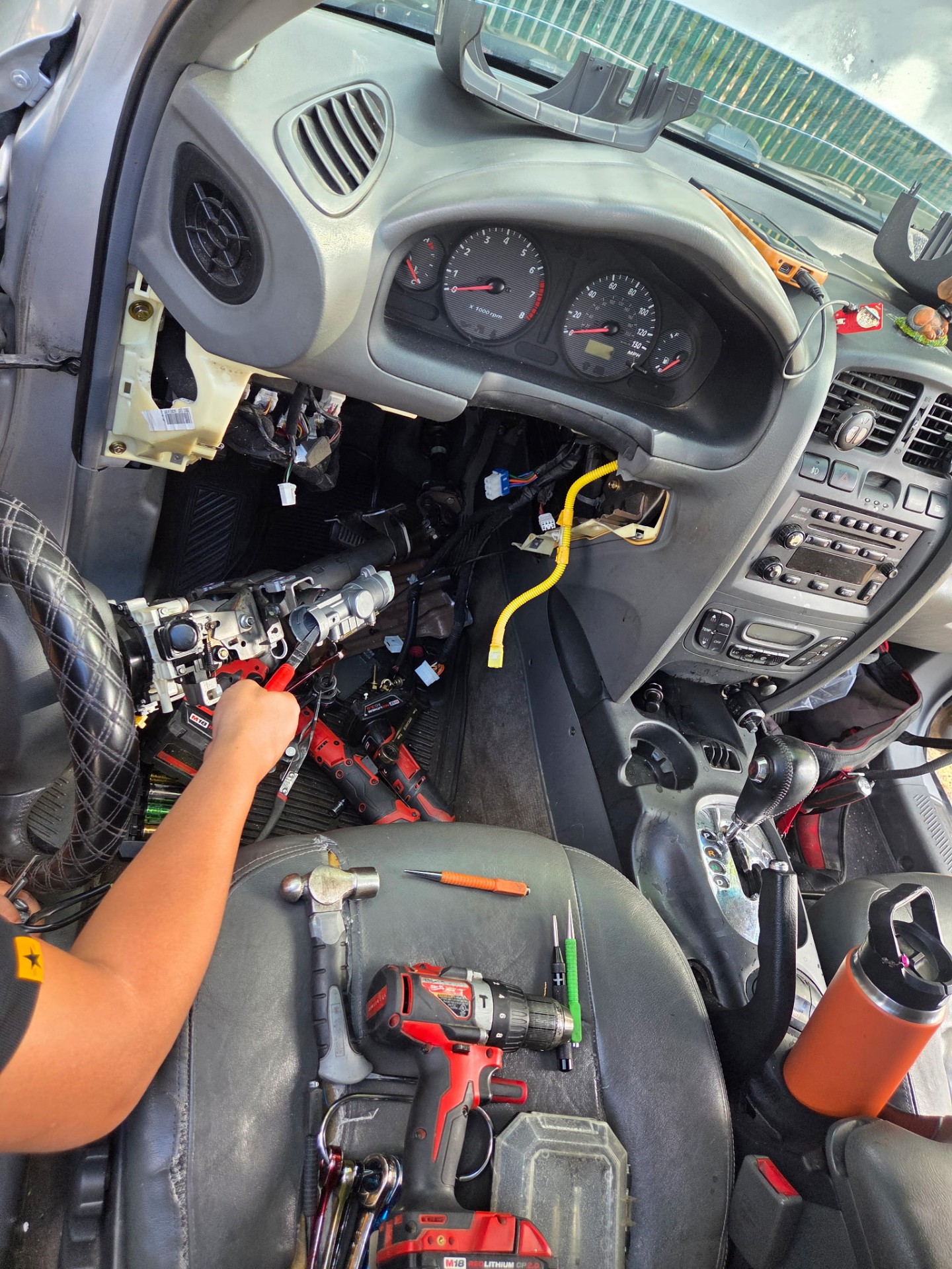 Vehicle dashboard disassembled with the steering column removed for ignition and steering lock repair